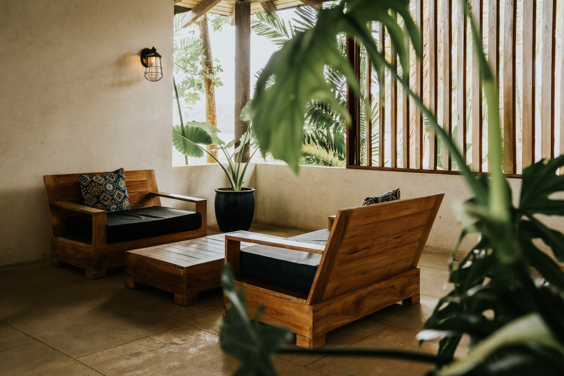 Villa Nomada — teak lounge chairs on the shaded terrace